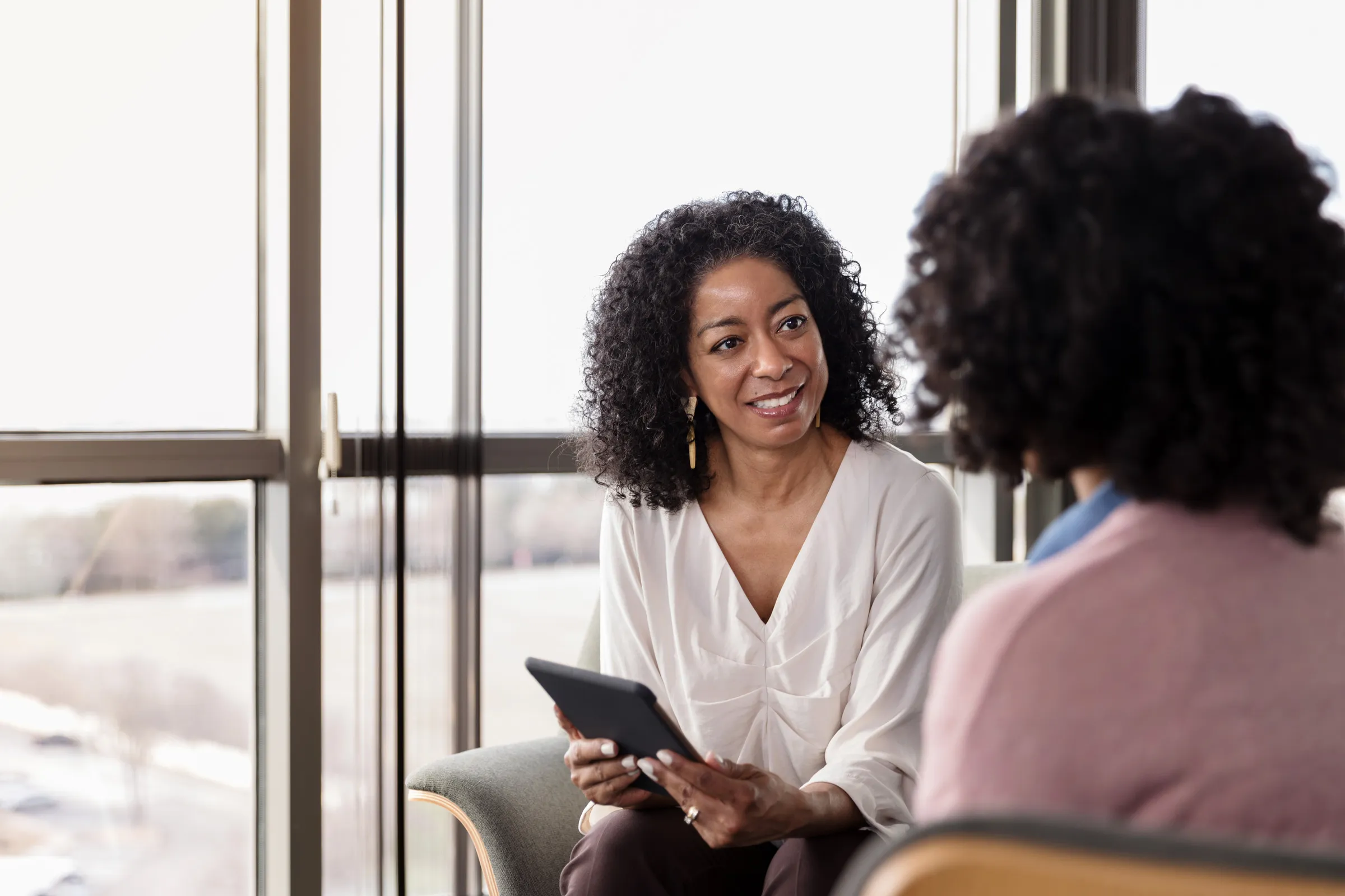 Two women in a warm, supportive conversation.